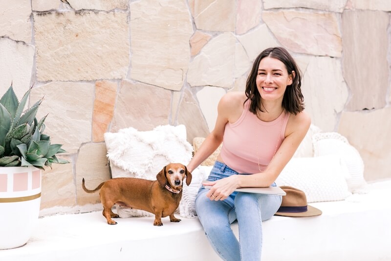 Emma Kate web design mentor sitting outside with her dog. Wispr Flow review: the AI voice-to-text tool every web designer needs.
